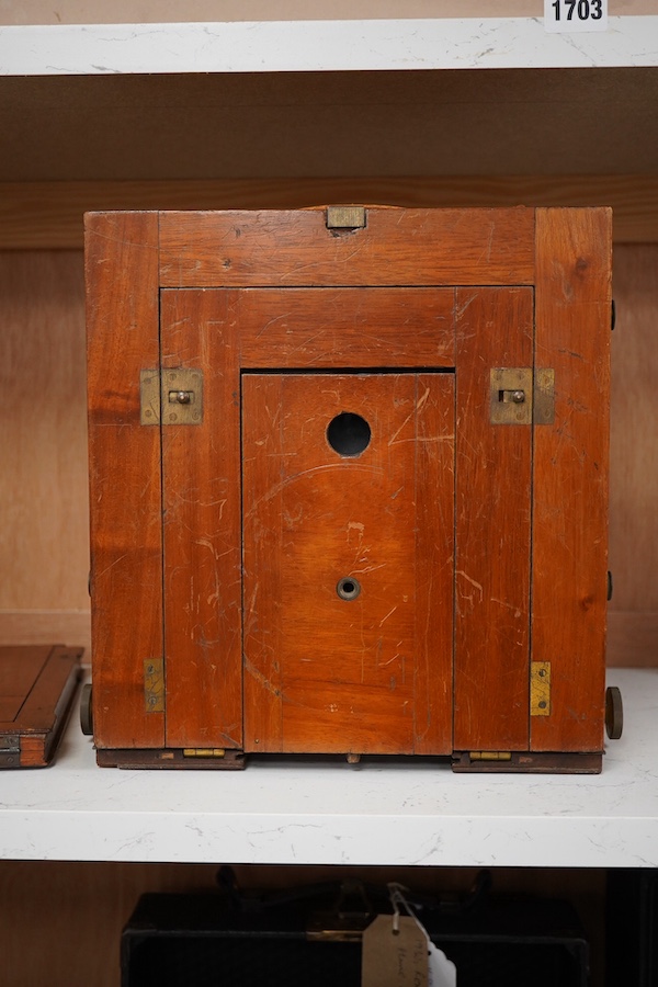 An early 20th century brass mounted mahogany full plate camera, together with a glass negative holder. Condition - fair to good.